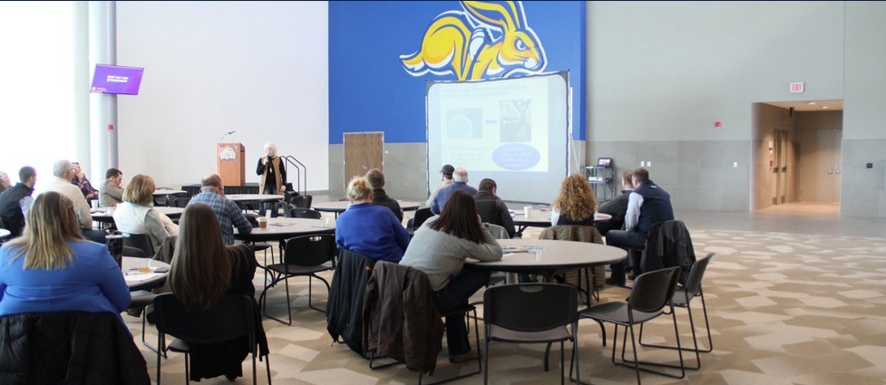 A group listens to a presentation.